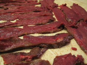 Cut venison into 1/4 inch thick strips